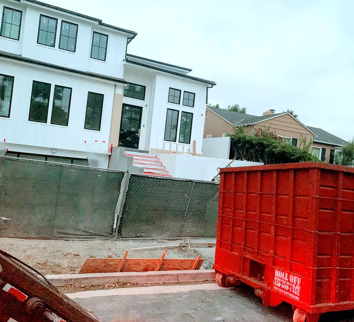 Red construction dumpster on a new home build site in Los Angeles