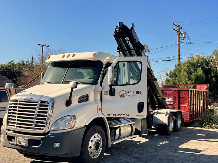 Roll Off Dumpster Rental truck arriving for a residential dumpster delivery